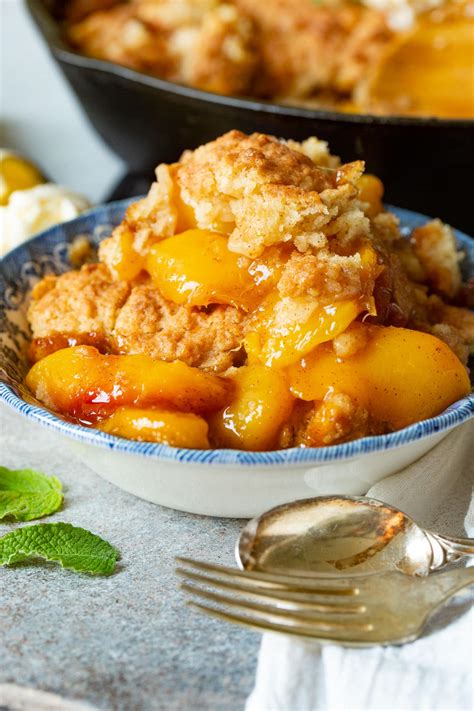 Southern peach - Southern Peach Cobbler. If using fresh peaches, peel and slice peaches. In a bowl, add the peaches and 3/4 cup sugar. Stir to combine. Preheat oven to 350ºF. Pour the melted butter into a 9×13 pan. Mix together the self-rising flour and sugar. Slowly, whisk in the milk. Pour over the melted butter.